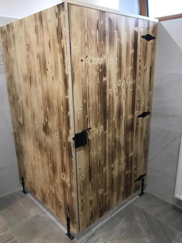 a wooden door with black hinges on a wall at Bezručova škola in Staré Hamry