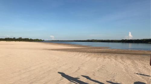 a shadow of a person on the beach at San Isidro Hotel in Mercedes