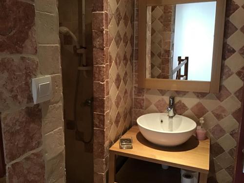 a bathroom with a sink and a mirror at Maison de vacances sud Ardèche in Berrias Et Casteljau