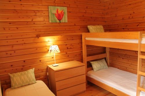 a cabin with two bunk beds and a lamp at Serapicos House in Bragança