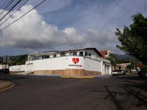 a building with a heart sign on the side of it at Casa Altamira in San Pedro Sula