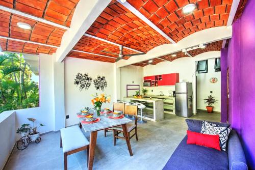 a kitchen and living room with a table and chairs at CASA KANELO in Sayulita
