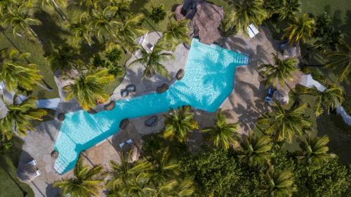 an aerial view of a swimming pool with palm trees at The Palm Island Resort in Palm Island
