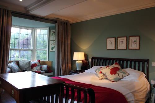 a bedroom with a bed and a couch at The Spread Eagle in Clitheroe