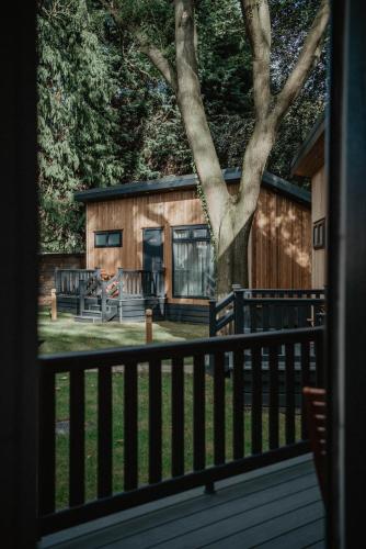 a house with a fence and a tree at Bowburn Hall Hotel in Durham