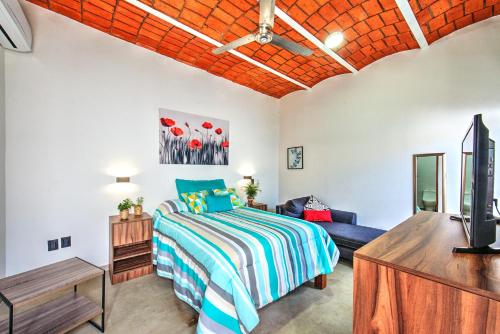 a bedroom with a bed and a couch at CASA KANELO in Sayulita