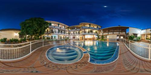 a swimming pool in front of a building at Hotel El Virrey Boutique Honda in Honda