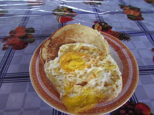 a plate with an egg and bread on a table at San Blas Islands - Private Cabin Over-the-Ocean including Meals in Mandinga