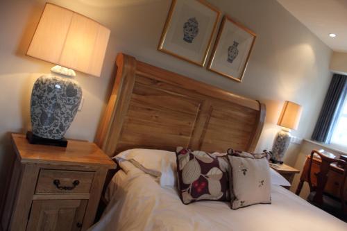a bedroom with a bed with a wooden head board at The Spread Eagle in Clitheroe