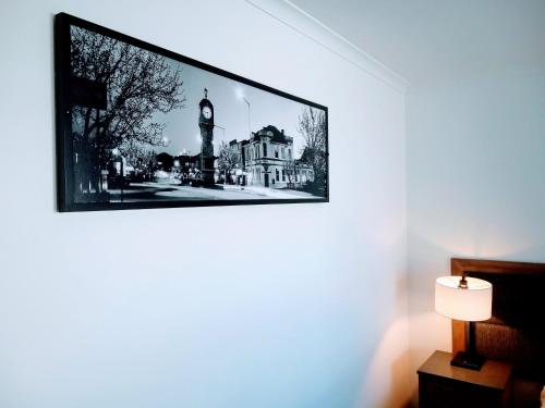 a picture of a clock tower on a wall at Winning Post Motor Inn in Mudgee