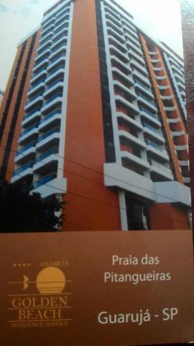 a tall building with a sign in front of it at Residencial flat Golden beach.. in Guarujá