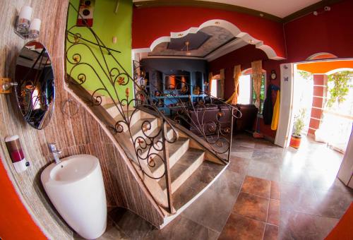 a bathroom with a spiral staircase in a house at Hostal Casa de Grethel in Flores