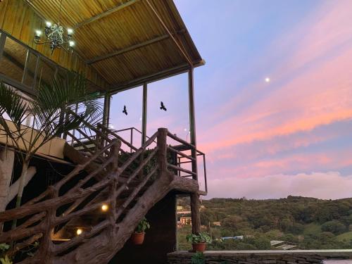 a building with birds flying in the sky at Cabinas Vista Al Golfo in Monteverde Costa Rica