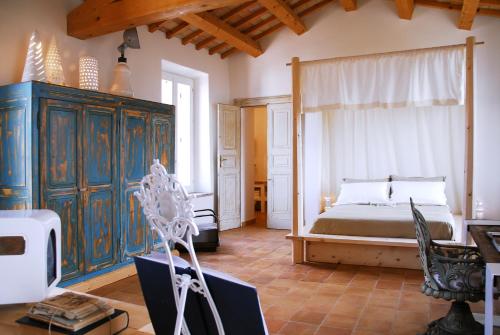 a bedroom with a bed and a large window at Castello di Granarola Relais - Adults Friendly - in Gradara