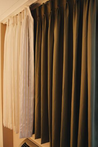 a room with black and white curtains at All Seasons Inn & Suites in Memphis