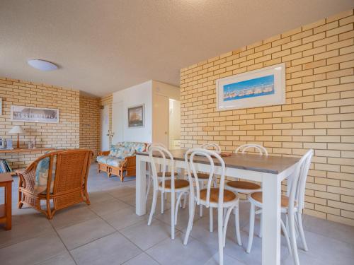 a dining room with a table and chairs at Golden Shores U7 21 Landsborough Parade in Caloundra