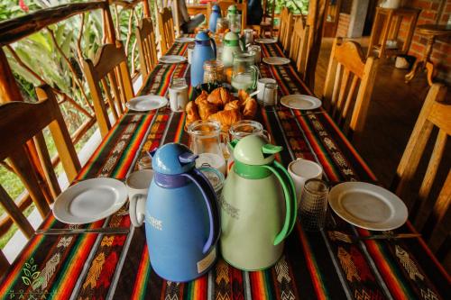 a long table with blue and green bottles on it at Hostal Pakay in Tena