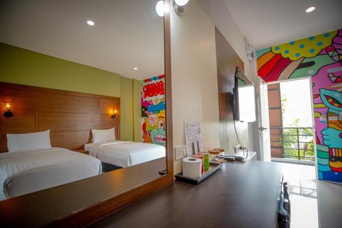 a bedroom with a bed and a mirror at Smart Hotel in Lam Luk Ka