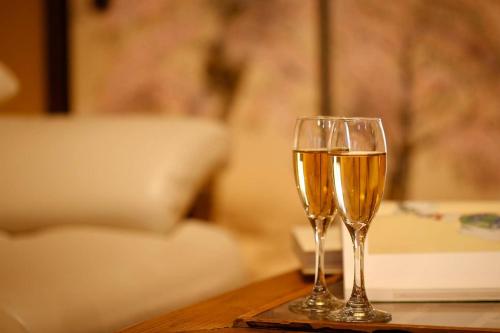 two glasses of champagne sitting on a table at Yamagata Kyomachi Hatago Nishijin in Kyoto