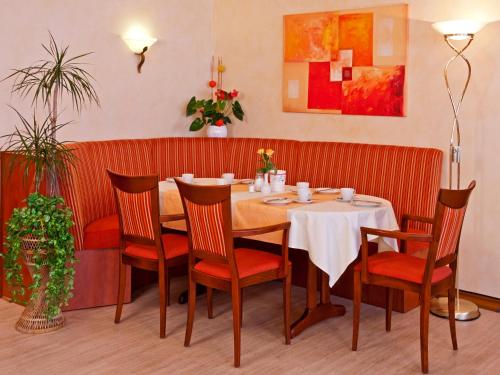 a dining room with a table and chairs at Hotel Rosenhof in Kerpen
