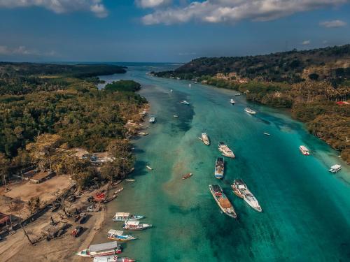 an aerial view of a river with boats in the water at The Dafish Ceningan in Nusa Lembongan