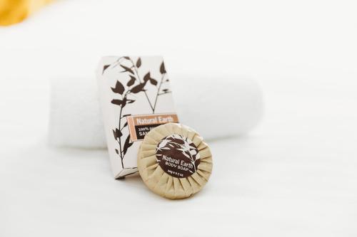 a wooden medal on a white table next to a box at Coniston Hotel Wollongong in Wollongong