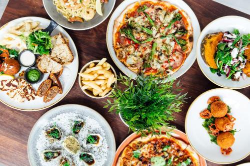 a group of plates of food on a table at Coniston Hotel Wollongong in Wollongong