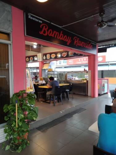a restaurant with people sitting at tables in a restaurant at City Inn in Kuching