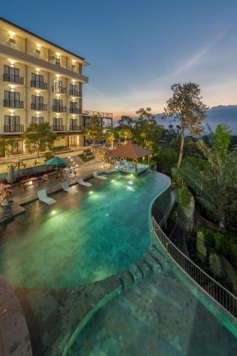 a large swimming pool in front of a hotel at Nava Hotel Tawangmangu in Tawangmangu
