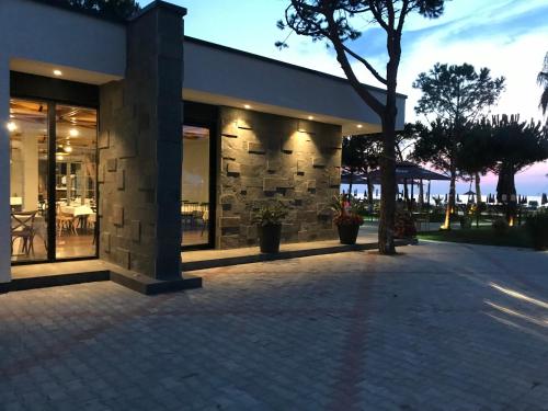 a building with windows and a tree in front of it at Bellavista Qerret Apartments in Golem