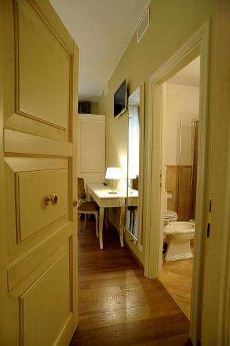 a hallway with a room with a desk and a door at Le Camere Del Ceccottino in Pitigliano
