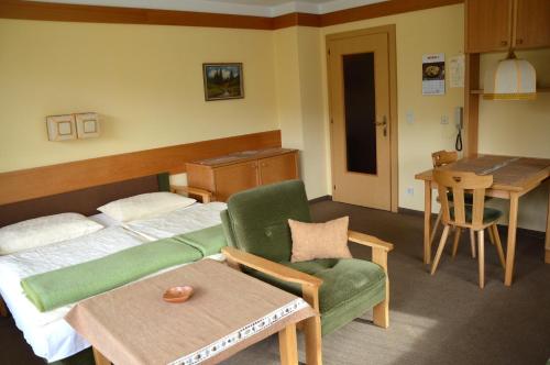 a hotel room with a bed and a chair and a table at Ferienhaus Antonia in Ehrwald