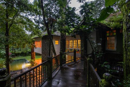 an exterior view of a house with a wooden deck at Mystic Mayapott, Thekkady in Thekkady