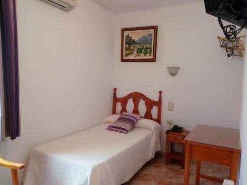 Tempat tidur dalam kamar di Hostal Rural Montual