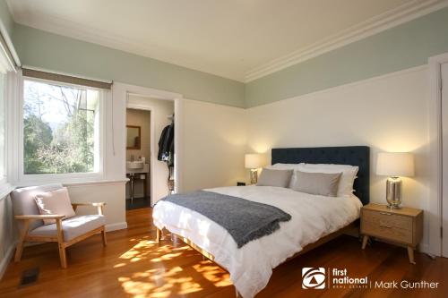 a bedroom with a bed and a chair and a window at Mi Casa - Healesville in Healesville