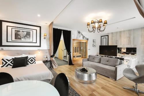 a hotel room with a bed and a living room at Hotel Atelia in Lublin