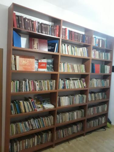 a book shelf filled with lots of books at VILA DISHA in Tirana