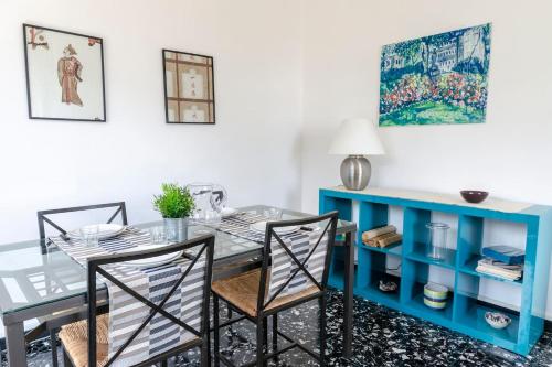 a dining room with a blue table and chairs at JOIVY Sea View Flat with Balcony, Cinque Terre in Monterosso al Mare