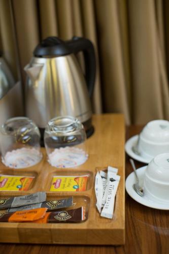 a wooden table with a tea kettle and dishes on it at Ruba Palace Thermal Hotel in Bursa