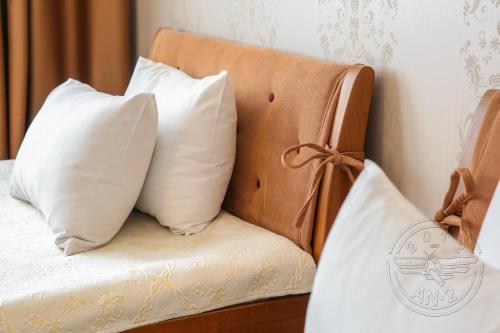 a couch with two pillows on top of it at Antwo-Hotel in Kharkiv