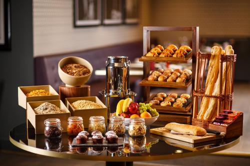 a table topped with lots of different types of food at Mercure Gloucester Bowden Hall Hotel in Gloucester
