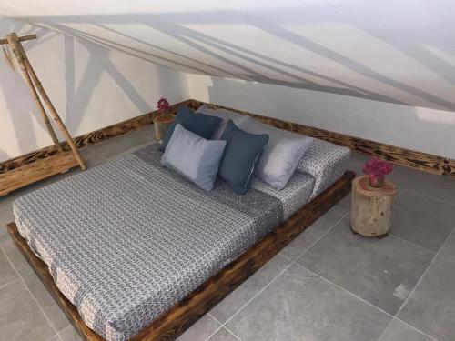 a wooden bed with blue pillows in a room at El Lagar de los Abuelos in Arcos de la Frontera