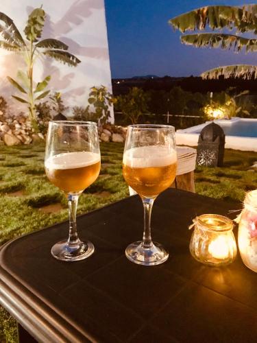 two glasses of beer sitting on a table at El Lagar de los Abuelos in Arcos de la Frontera