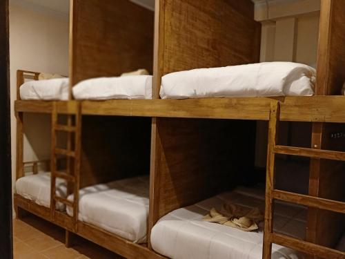 a group of bunk beds in a room at Happy Penida Hostel in Nusa Penida