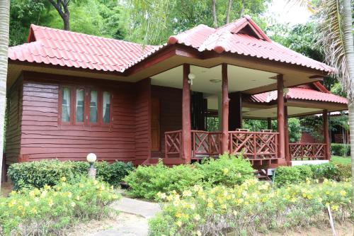 a small red house with a red roof at The Thai Elephant Conservation Center Lampang in Lampang