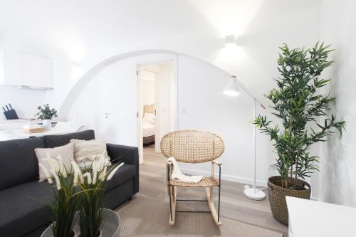 a living room with a black couch and plants at Lavradores Boutique Guesthouse in Évora