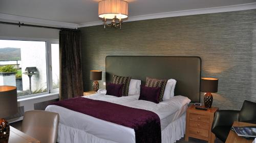 a bedroom with a large bed and a window at Beech Hill Hotel & Spa in Windermere