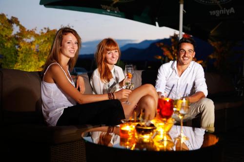 a group of three people sitting around a table at Hotel Raffl in Bolzano