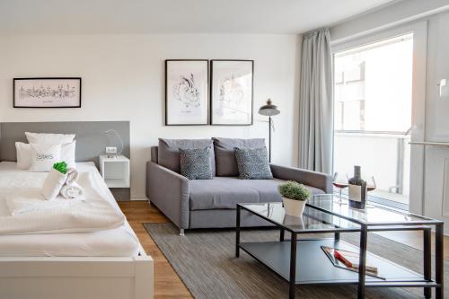 a living room with a couch and a coffee table at StayS Apartments in Nuremberg
