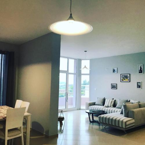 a living room with a couch and a table at NYC Modern & Spacious Apartament 5 min from seaside in Orikum